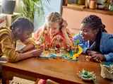 People playing with the LEGO Friends Beach Resort set.