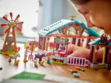 Child playing with LEGO farm.