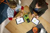 Overhead view of two people building LEGO Eclipse.