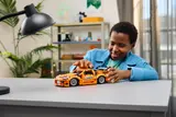 Child playing with LEGO Technic Supra.