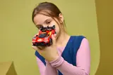 Girl inspecting LEGO Ferrari 499P.
