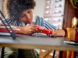Child holding LEGO Ferrari F40.
