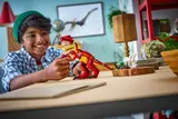 Boy plays with LEGO raptor.