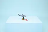 LEGO shark scene on blue cube.