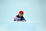 Child playing with LEGO shark.
