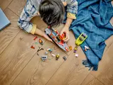 Child playing with Fire Rescue Boat set.