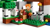 Alex in shelter with torch and chest.