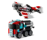 Biplane flying, truck on ground.