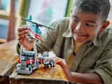 Child playing with helicopter and truck.