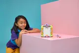 Child admiring LEGO photo frame.