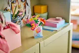 LEGO flower vase on cabinet.