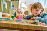 Child playing with LEGO perfume bottle.