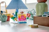 LEGO perfume bottle on desk.