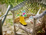 LEGO rain boot on a wicker chair.