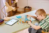 Child building with digital instructions.