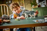 Boy playing with LEGO wolf.