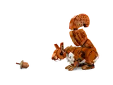 LEGO squirrel looking at acorn.