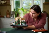 Woman holding LEGO French Café.