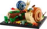 LEGO snails on a log with foliage.