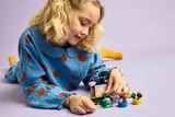 Child playing with LEGO movie set.