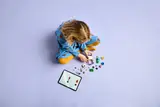 Child building LEGO with digital instructions.