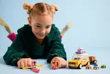 Child playing with LEGO Friends travel car set