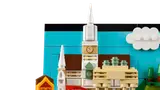 Close-up of LEGO church spire and clock detail.