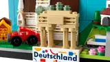 Brandenburg Gate replica with red car in LEGO set.