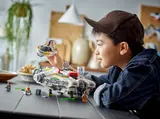 Child playing with LEGO Ghost set.