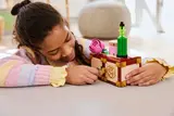 Girl winding key on LEGO Dormitory chest.