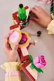 Hands opening LEGO storage compartment.