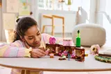 Girl playing with open LEGO Dormitory.