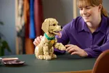Woman playing with LEGO puppy.