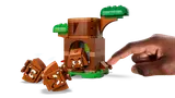 Hand activating Goomba ejection feature in LEGO set.