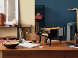 Partially built LEGO Grand Piano on a desk.