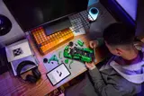 Builder working on green LEGO Technic Bugatti Chiron on a desk.