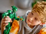 Child examining Green Goblin's face.