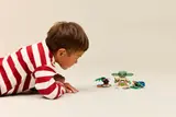 Child focused on Grogu set