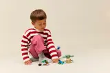 Child playing with Grogu set