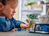 Child admiring LEGO Grogu