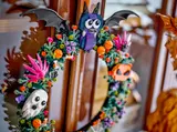 Close-up of bat, ghost, and pumpkin on wreath.