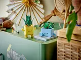 LEGO plants on a stylish green desk.