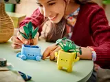 Hands swapping LEGO plant tops.