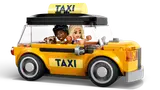Yellow taxi with minifigures and dog.