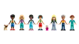 Eight LEGO Friends minifigures and a dog.