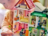 Child playing with upper Heartlake City apartments.