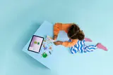 Child building Bunny Hotel with digital instructions.