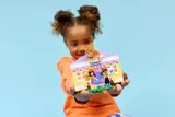 Child proudly presenting Heartlake City Bunny Hotel.