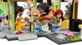 Close-up of minifigure interactions outside cafe.