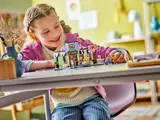 Child playing with LEGO Heartlake City Cafe.